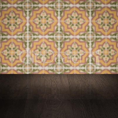 Wood table top and blur vintage ceramic tile pattern wall