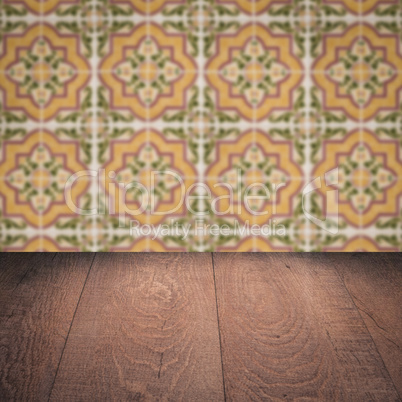 Wood table top and blur vintage ceramic tile pattern wall