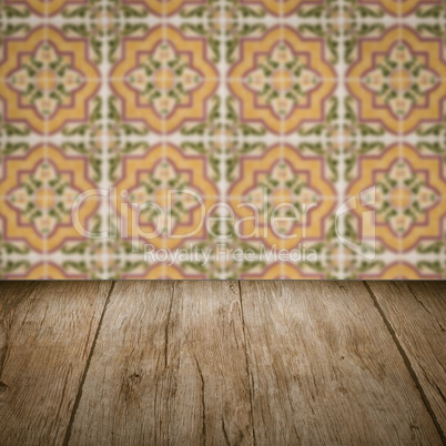 Wood table top and blur vintage ceramic tile pattern wall