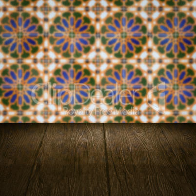 Wood table top and blur vintage ceramic tile pattern wall Wood table top and blur vintage ceramic tile pattern wall