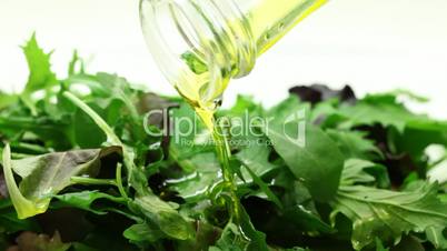 Pouring oil into salad