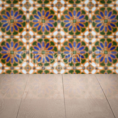 Wood table top and blur vintage ceramic tile pattern wall