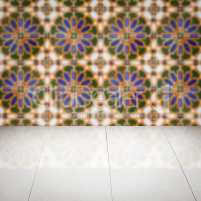 Wood table top and blur vintage ceramic tile pattern wall Wood table top and blur vintage ceramic tile pattern wall