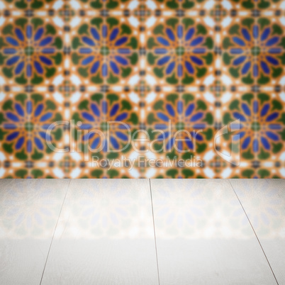 Wood table top and blur vintage ceramic tile pattern wall