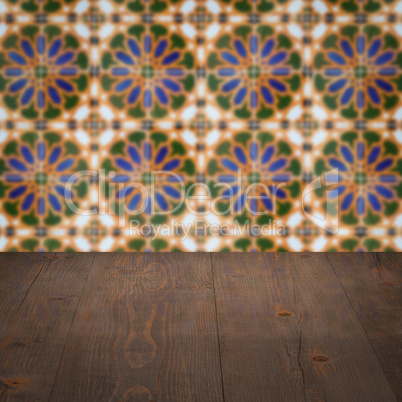 Wood table top and blur vintage ceramic tile pattern wall