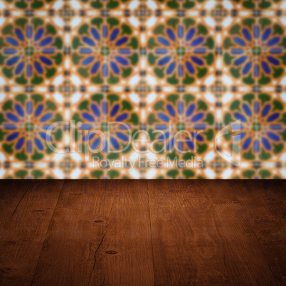 Wood table top and blur vintage ceramic tile pattern wall