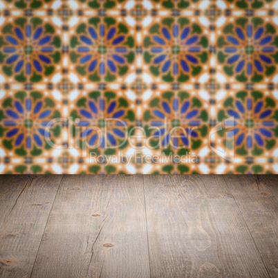 Wood table top and blur vintage ceramic tile pattern wall