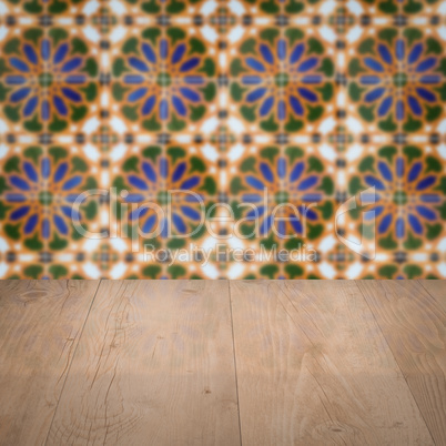 Wood table top and blur vintage ceramic tile pattern wall