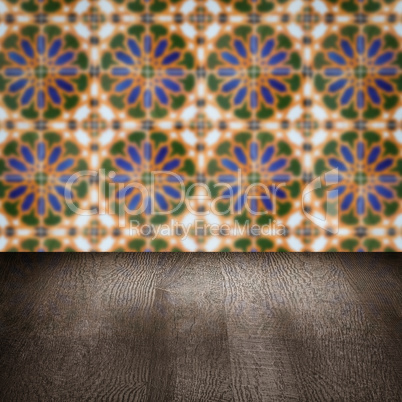 Wood table top and blur vintage ceramic tile pattern wall