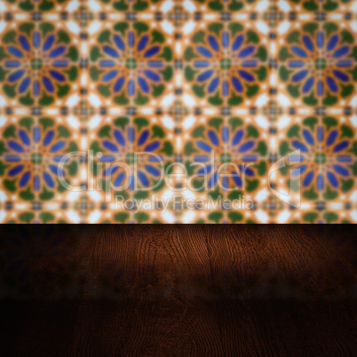 Wood table top and blur vintage ceramic tile pattern wall