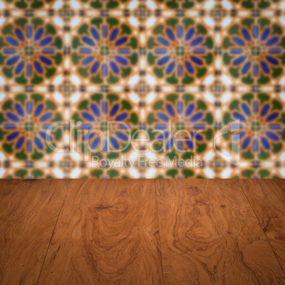 Wood table top and blur vintage ceramic tile pattern wall