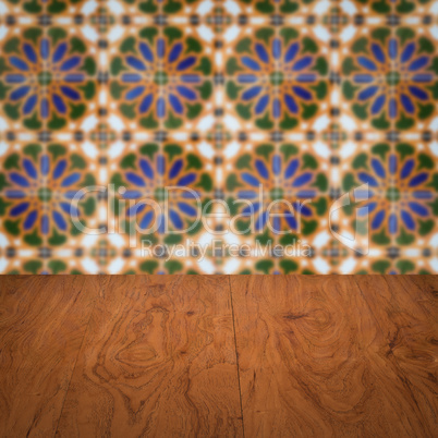 Wood table top and blur vintage ceramic tile pattern wall