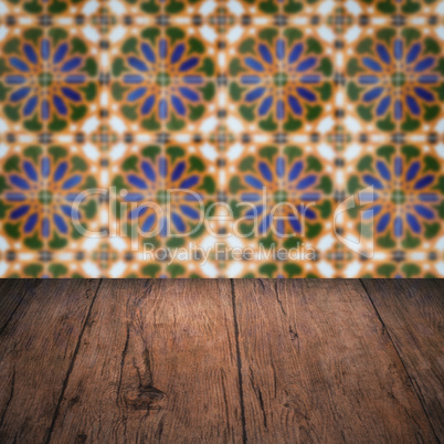 Wood table top and blur vintage ceramic tile pattern wall