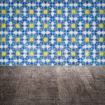 Wood table top and blur vintage ceramic tile pattern wall