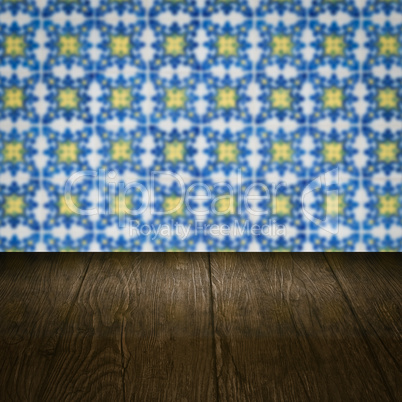 Wood table top and blur vintage ceramic tile pattern wall