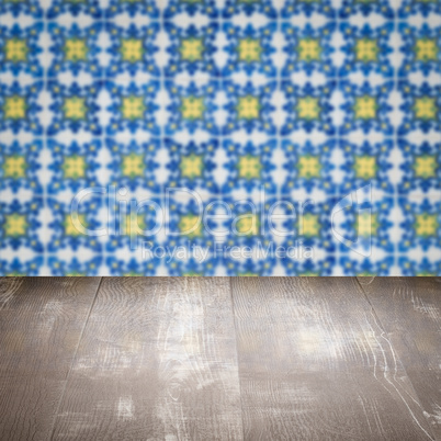 Wood table top and blur vintage ceramic tile pattern wall