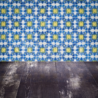 Wood table top and blur vintage ceramic tile pattern wall