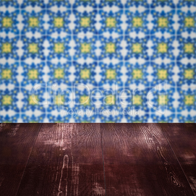 Wood table top and blur vintage ceramic tile pattern wall