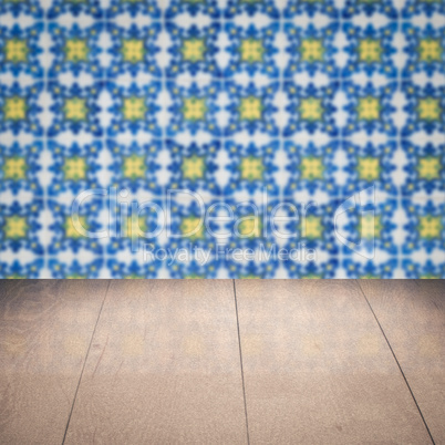 Wood table top and blur vintage ceramic tile pattern wall