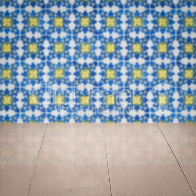 Wood table top and blur vintage ceramic tile pattern wall