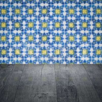 Wood table top and blur vintage ceramic tile pattern wall