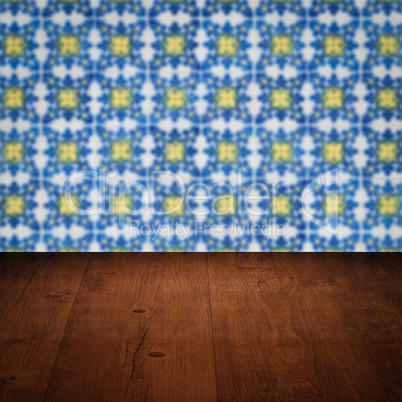 Wood table top and blur vintage ceramic tile pattern wall