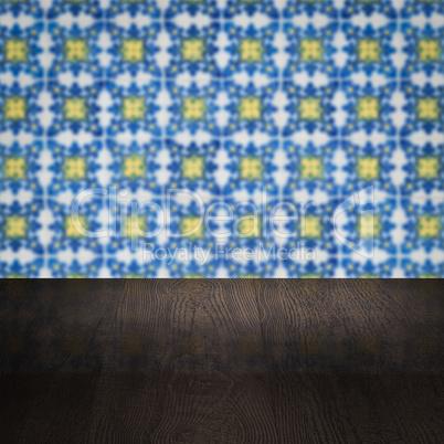 Wood table top and blur vintage ceramic tile pattern wall