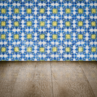 Wood table top and blur vintage ceramic tile pattern wall