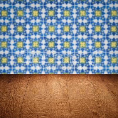 Wood table top and blur vintage ceramic tile pattern wall