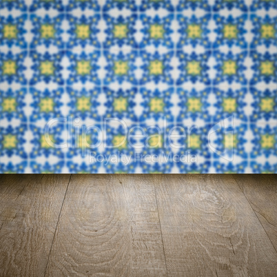 Wood table top and blur vintage ceramic tile pattern wall