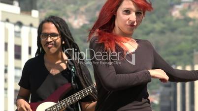 Redheaded Teen Female Dancing With Guitarist