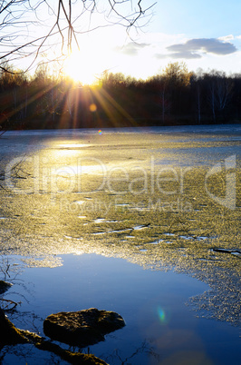 Spring landscape with melting ice on the lake on a clear day