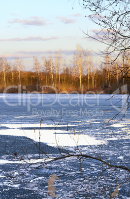 Spring landscape with melting ice on the lake on a clear day