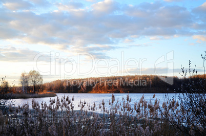 Spring landscape with melting ice on the lake on a clear day