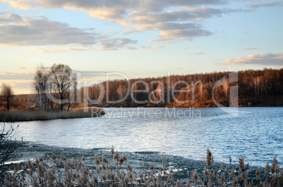 Spring landscape with melting ice on the lake on a clear day