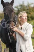 Middle Aged Woman Stroking Her Horse
