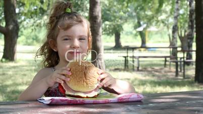 little girl eat big sandwich