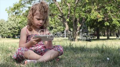 little girl play with tablet