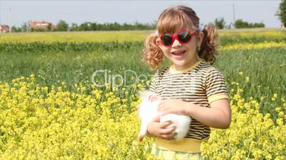 little girl with white dwarf bunny
