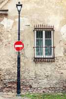 No entry sign hanging on lamp post