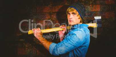 Composite image of profile of hipster standing with axe