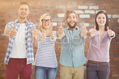 Composite image of portrait of smiling business people with thum