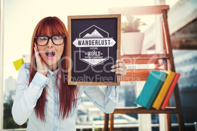 Composite image of smiling hipster woman holding blackboard