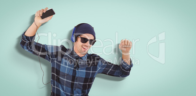 Composite image of portrait of happy hipster wearing headphones