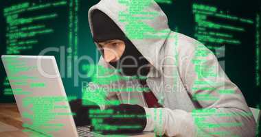 Composite image of hacker using laptop