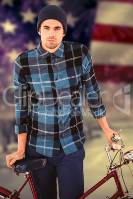 Composite image of portrait of hipster standing with bicycle