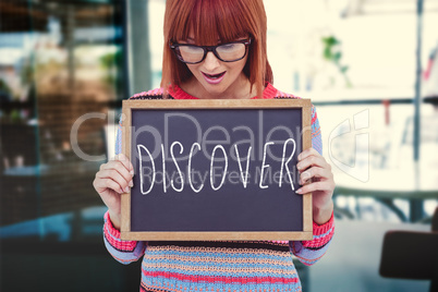 Composite image of smiling hipster woman holding blackboard