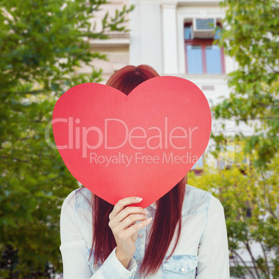 Composite image of attractive hipster woman behind a red heart