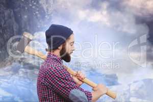 Composite image of side view of hipster with axe