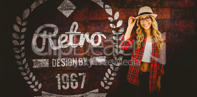 Composite image of gorgeous smiling blonde hipster posing